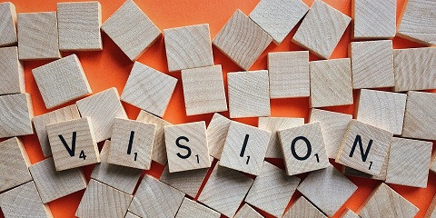 Holzwürfel mit Wort Vision Holzwürfel mit Buchstaben, die das Wort Vision ergeben